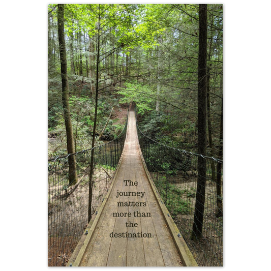 swinging bridge at Cumberland Mountain State Park in Crossville, Tennessee, with the quote "The journey matters more than the destination"